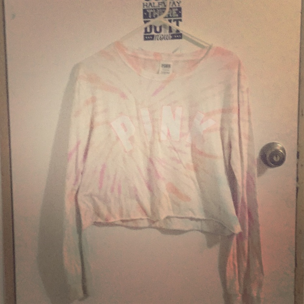 A tie-dyed pink shirt the shirt was made tie-dyed